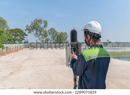 Environmental officer setting sound level meter for monitor is part of the prevention of environmental impacts at factory. Royalty-Free Stock Photo #2289071829