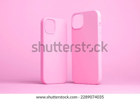 set of two pink cases for iPhone 15 and 14 Plus or iPhone 13 and 13 mini back side view isolated on pink background, monochrome colours phone case mock up