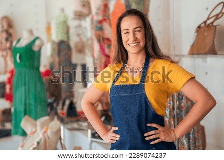 Employee poses for portrait in clothing store Royalty-Free Stock Photo #2289074237