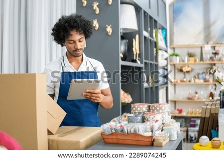 Employee checks products and inventory in home decor store Royalty-Free Stock Photo #2289074245