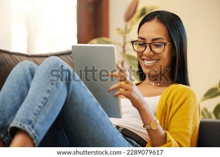 Tablet, relax and woman reading in home living room on sofa, social media or ebook. Technology, touchscreen and happy person web scrolling, online browsing or streaming video, movie or film in lounge