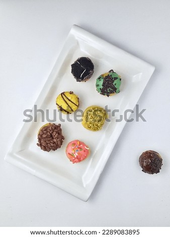 mini j pops donuts at the White plate Royalty-Free Stock Photo #2289083895