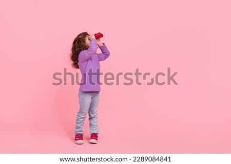 Full length photo of funky dreamy small kid wear violet sweater looking binoculars empty space isolated pink color background