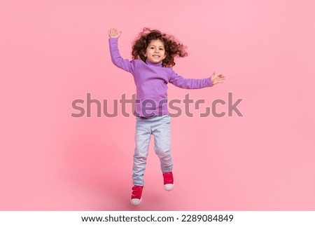 Full length photo of cheerful funky small kid wear violet sweater jumping high isolated pink color background Royalty-Free Stock Photo #2289084849