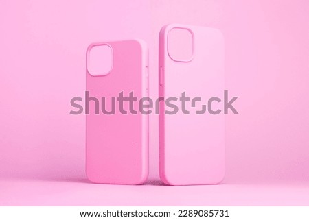 set of two pink cases for iPhone 15 and 14 Plus or iPhone 13 and 13 mini back side view isolated on pink background, monochrome colours phone case mock up Royalty-Free Stock Photo #2289085731