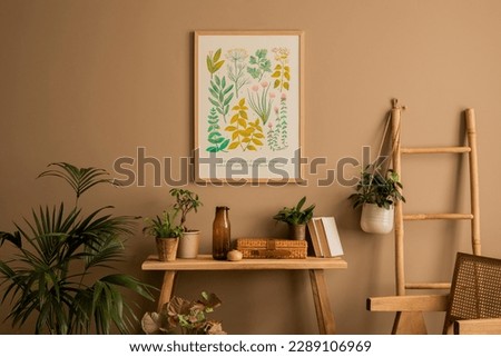 Warm composition of living room interior with mock up poster frame, plants in flowerpots, rattan armchair, wooden bench, books, braided box, brown wall and personal accessories. Home decor. Template.