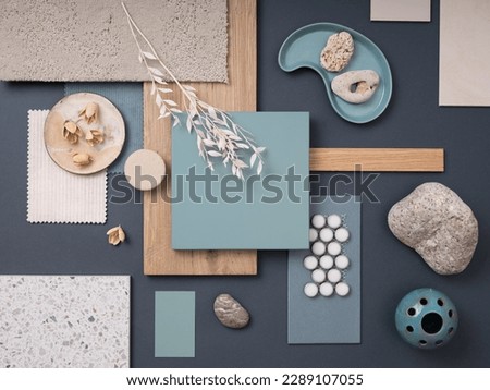 Creative flat lay composition with textile and paint samples, panels and cement tiles. Stylish interior designer moodboard. Blue and beige color palette. Copy space. Template. 