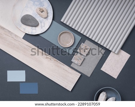 Modern flat lay composition with cement tiles, panels, facing, stones. Stylish interior designer moodboard. Blue, blue and gray color palette. Copy space. Template. 