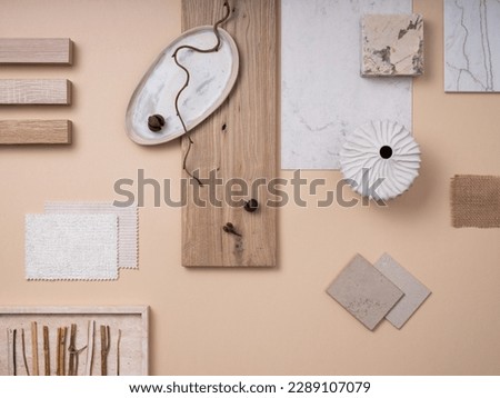 Creative flat lay composition with textile and paint samples, panels and cement tiles. Stylish interior designer moodboard. Light beige and gray color palette. Copy space. Template. 