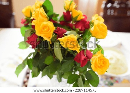 bouquet of red and yellow roses in a vase. Actual photo of a homemade rose flower bouquet.