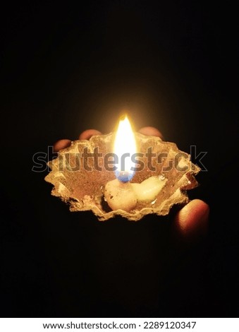 Festival of lights celebration. Diya oil lamp lit on hand