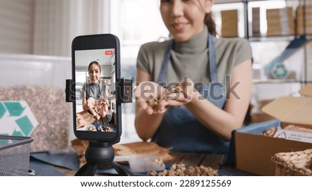 SME owner go green net zero retail store live stream talk on phone showing eco care plastic free packaging box Asia people young woman record video on   reel  shop happy side hustle