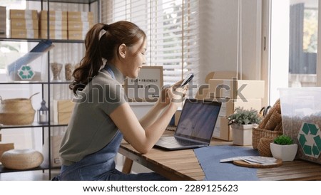 Go green SME owner reply chat comment online talk or set up chatbot on phone. Young seller asia woman typing mobile at home office easy selling CRM platform for eco friendly shop retail net zero store Royalty-Free Stock Photo #2289125623
