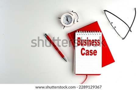 BUSINESS CASE text on a notebook , red pen and notebook, business concept, white background