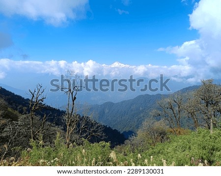Panoramic landscape view of scenic snowcapped Kanchenjunga from east Sikkim, India. It is the third-highest mountain in the world. It is also spelled Kangchenjunga, Kanchanjanghā, Khangchendzonga. Royalty-Free Stock Photo #2289130031