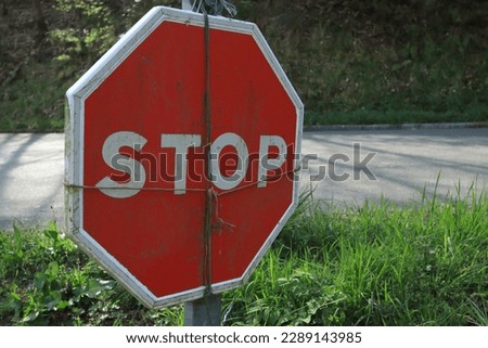 Road sign tied with ropes