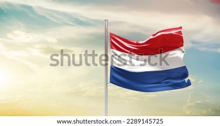 Waving flag of Netherlands in beautiful sky. Netherlands flag for independence day.
