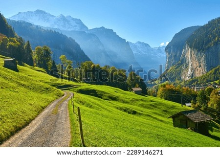 Mountain morning view with old wooden barns near the road in Lauterbrunnen valley in Switzerland. Royalty-Free Stock Photo #2289146271