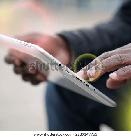 African american man uses tablet computer. Black man hands holds tablet pc, close up. African works with tablet computer, flips through feed on social networks