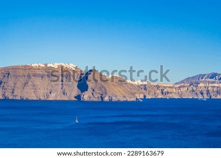 amazing panorama of Santorini with Fira and Imerovigli a Greek Aegean island.he whitewashed, cubiform houses of its 2 principal towns, Fira and Oia, cling to cliffs above an underwater caldera  Royalty-Free Stock Photo #2289163679
