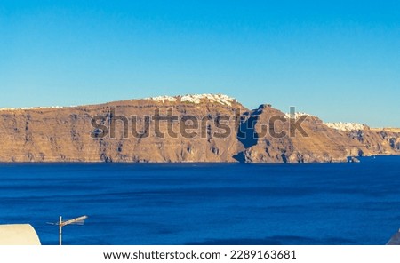 amazing panorama of Santorini with Fira and Imerovigli a Greek Aegean island.he whitewashed, cubiform houses of its 2 principal towns, Fira and Oia, cling to cliffs above an underwater caldera  Royalty-Free Stock Photo #2289163681