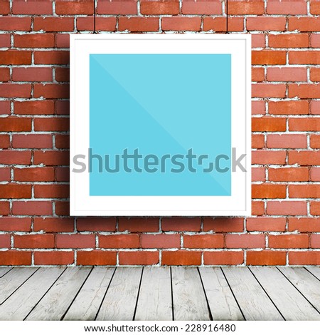 Poster mockup template with white square frame in brick room
