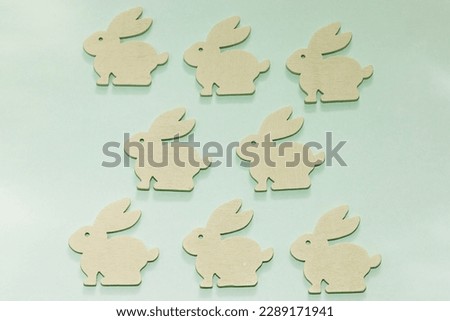 figurines of rabbits on a background of pastel colors, easter bunnies, background for a postcard