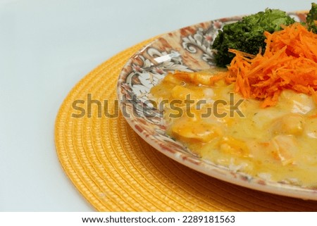 delicious cassava cream dish with shrimp, rice, broccoli and grated carrot