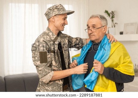 elderly father and son military flag of Ukraine