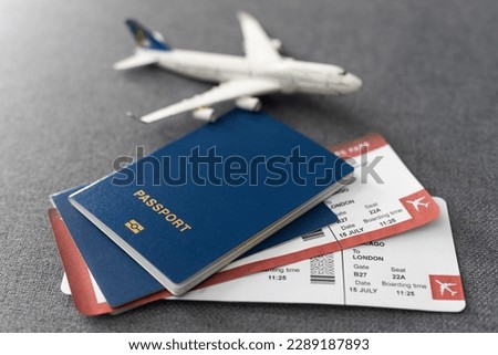 Plane tickets, passports and toy plane on table Royalty-Free Stock Photo #2289187893