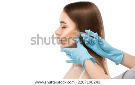 The cosmetologist makes injections of the cheekbones of a beautiful woman. Women's cosmetology in a beauty salon. Royalty-Free Stock Photo #2289190243