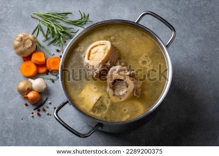 Boiled bone and broth. Homemade beef bone broth is cooked in a pot on. Bones contain collagen, which provides the body with amino acids, which are the building blocks of proteins. Royalty-Free Stock Photo #2289200375
