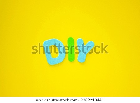 DIY: Abbreviation for Do it Yourself. DIY (Do It Yourself) made with colorful letters on yellow background with copy space. Royalty-Free Stock Photo #2289210441
