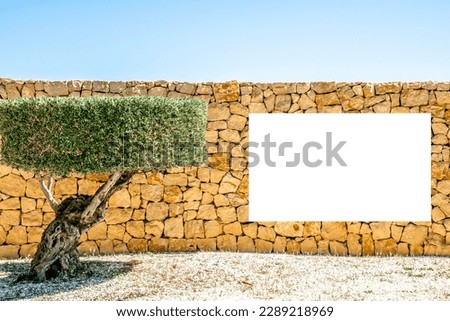 Mock up. Blank white horizontal advertising signboard, billboard, poster, information board on brown masonry wall of stone