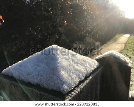 Gatepost with snow too on a very bright morning. Polarised lens as sun shines across image. Royalty-Free Stock Photo #2289228815