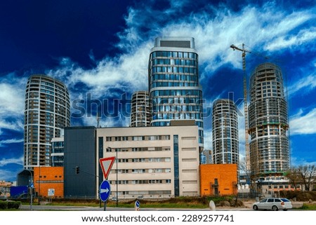 Bratislava city skyline, modern industrial buildings, and new high-rising apartments in Slovakia, with dramatic clouds