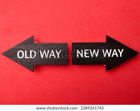 Wooden arrow with the word OLD WAY NEW WAY on a red background Royalty-Free Stock Photo #2289261741
