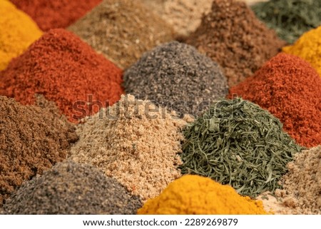 Assortment spices and herbs for cooking. Spice and seasoning. Various fragrant spice market. Heap different Asian Spices lies on wooden background Royalty-Free Stock Photo #2289269879