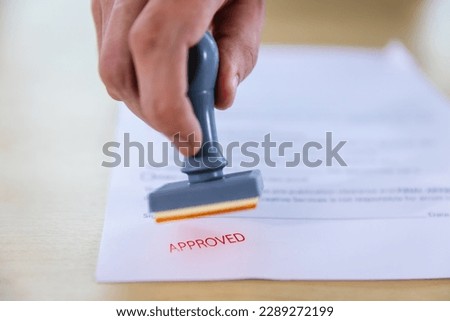 Business Man Stamping With Approved Stamp On Document. Business approve Stamp and certificate concept. Businessman Hands Stamping a document