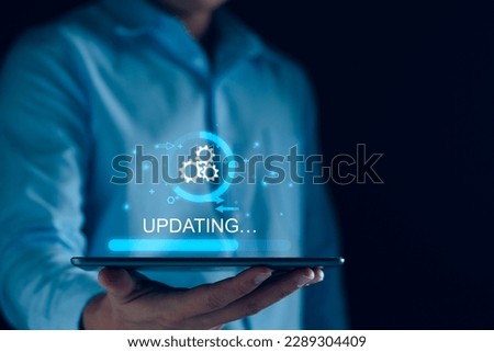 Operating system upgrade concept, installation app and software update process, modernize user equipment, update modern functions, developer released new version Improved security. User is downloading Royalty-Free Stock Photo #2289304409