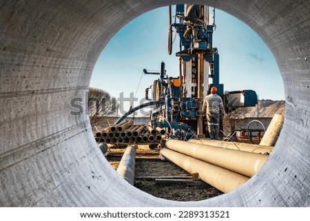 The drilling rig close-up is drilling a well against the background of the cloudy sky. Deep hole drilling. Geological exploration work. mineral exploration. Extraction of gas and oil Royalty-Free Stock Photo #2289313521