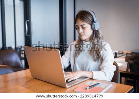 A female college student doing research and self-study in the study room. Education stock photo