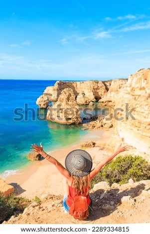 Praia da Marinha - Happy woman enjoying view of beautiful Beach Marinha in Algarve, Portugal Royalty-Free Stock Photo #2289334815