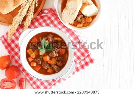 Gulasch or goulash in a white porcellain bowl. originated from Hungaria. perfect for recipe, article, or any cooking contents.  Royalty-Free Stock Photo #2289343873