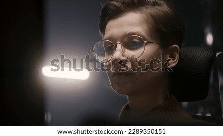 Close up shot of female PC user looking on computer screen in modern studio. Teenage girl makes video color correction, edits photo, develops design, writes programming code. Freelance and remote work