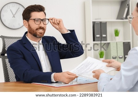 Businesspeople working with documents at table in office
