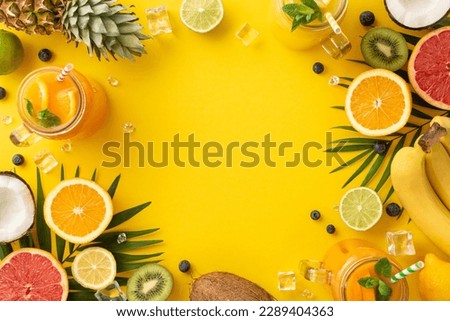 Capture the essence of summer with trendy flat lay photo of a fruity drink in a jar, complete with of orange, lemon, lime, grapefruit, set against a vibrant yellow background Royalty-Free Stock Photo #2289404363
