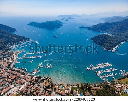 Aerial drone photo of the bustling Göcek Marina, located in the beautiful coastal town of Muğla, Turkey, captured by a drone showcasing the vibrant harbor and surrounding landscape. Royalty-Free Stock Photo #2289409523
