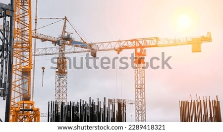 Construction of a nuclear power plant. Tower cranes on the background of the cooling tower. Royalty-Free Stock Photo #2289418321