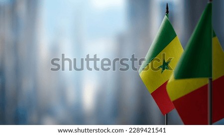 Small flags of the Senegal on an abstract blurry background. Royalty-Free Stock Photo #2289421541
